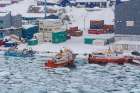 Fishing boats in the frozen harbor during a snow storm Ilulissat-Greenland Art Print
